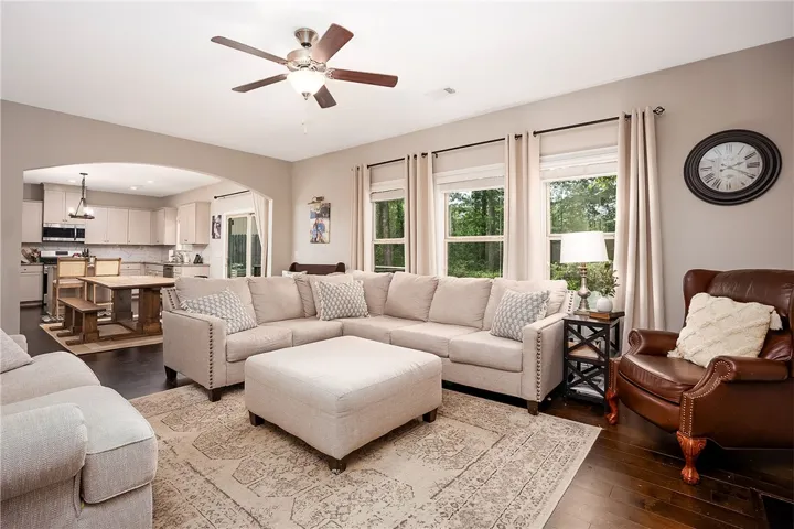 This inviting space features an open layout connecting the living area and kitchen, perfect for entertaining.