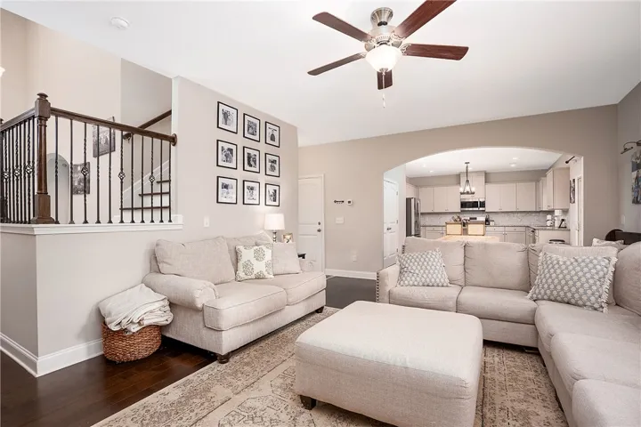 This inviting space features hardwood floors, an open layout, and a convenient kitchen nearby.