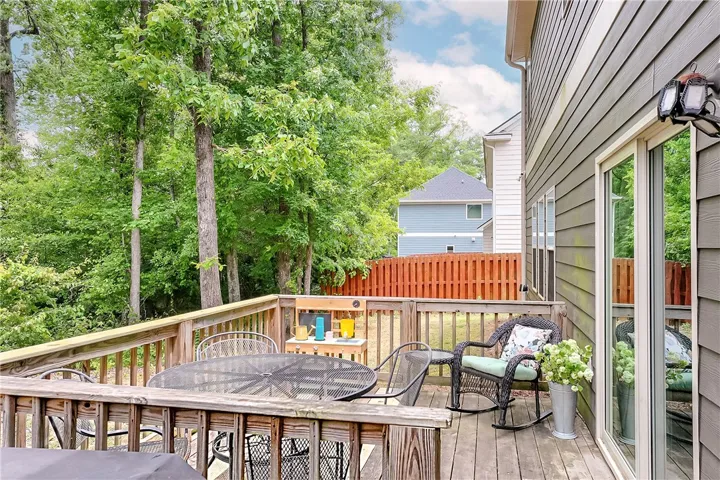 This spacious deck offers a tranquil retreat surrounded by lush greenery.