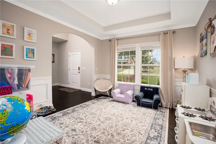 This versatile space features a bright window and sophisticated ceiling, perfect for various uses.