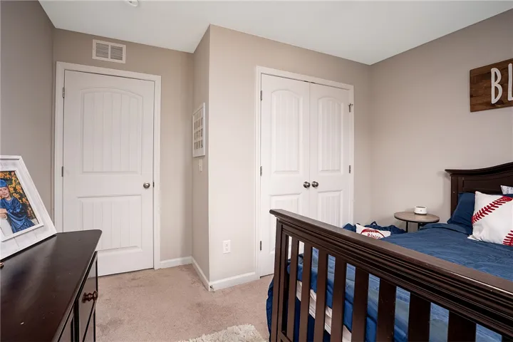 This cozy room offers comfortable carpeted flooring and efficient central air conditioning for year-round comfort.