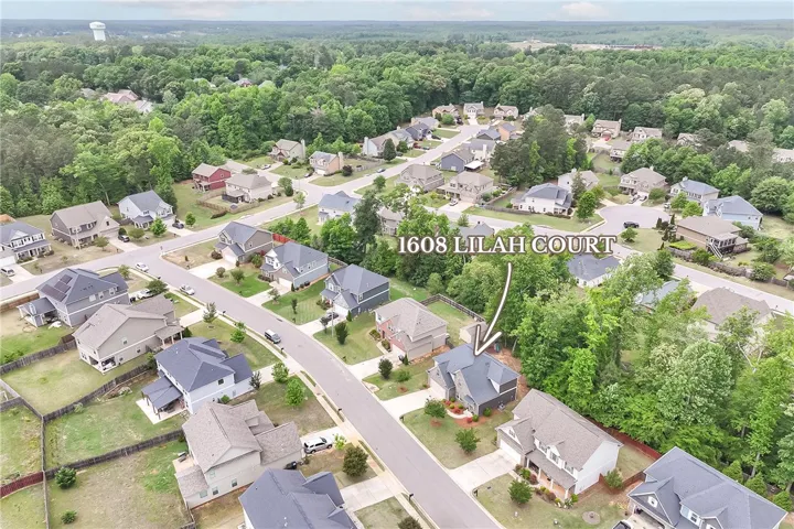 An aerial perspective reveals a vibrant neighborhood nestled among lush, mature trees.