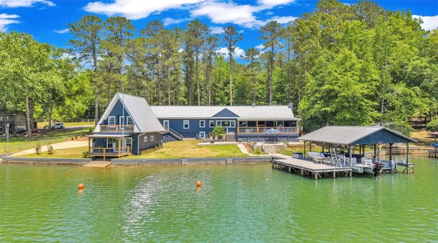 This tranquil lakeside residence features a private dock, offering serene water views and easy access.
