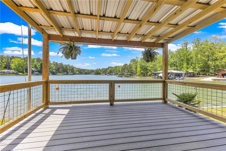 Enjoy tranquil water views from this expansive covered dock, perfect for outdoor living.