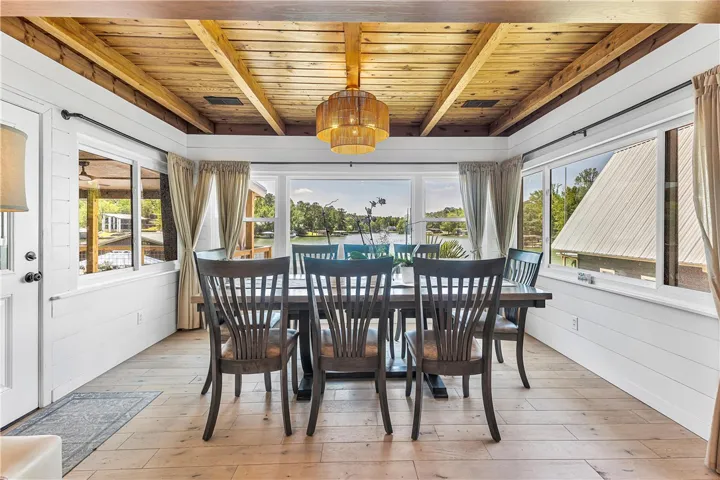 This dining area offers panoramic views of the water, creating an inviting space for gatherings.