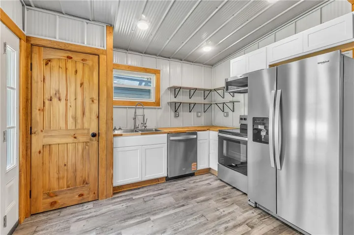 This kitchen features sleek countertops and modern appliances, creating a highly functional culinary space.