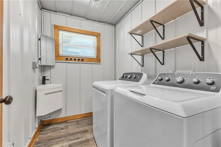 This functional utility room offers convenience and efficiency for all your laundry needs.