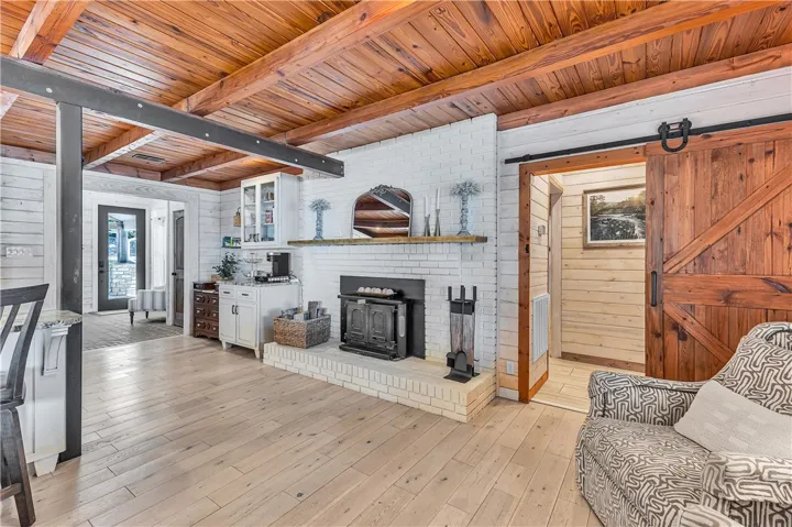 This living area features a warm fireplace and rich wood accents, creating an inviting atmosphere.