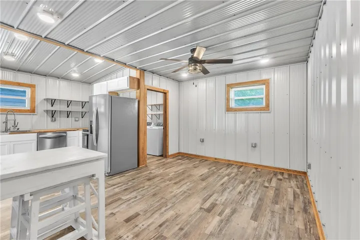 This versatile space features durable flooring and essential kitchen and laundry appliances.