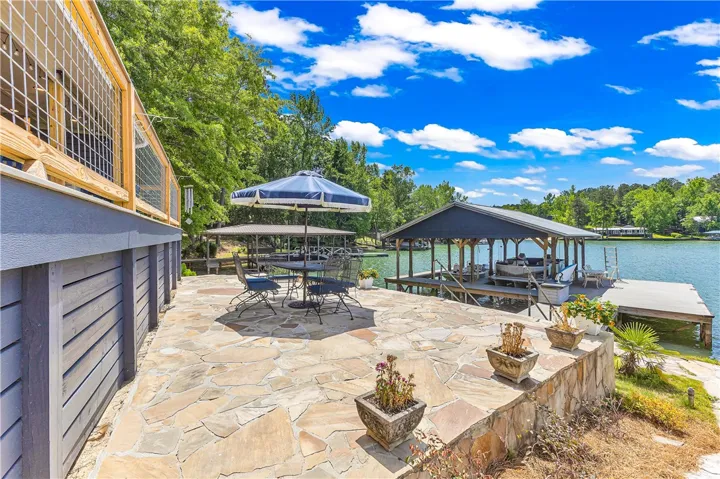 Enjoy lakeside living with a stone patio, private dock, and stunning water views.