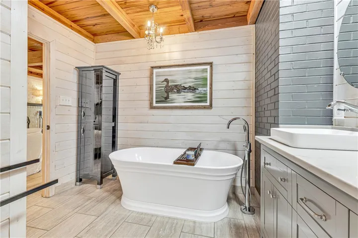 Relax in this luxurious bathroom featuring a freestanding tub and stylish vanity.