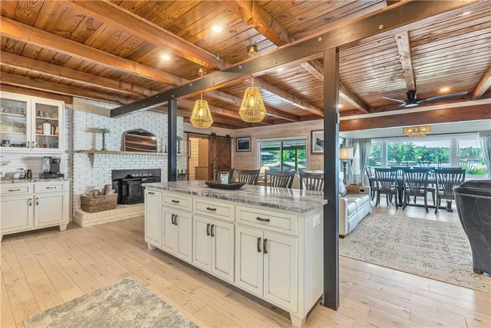 This inviting space features a kitchen island, a fireplace, and views of the outdoors.
