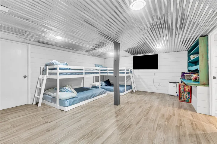 This spacious room features ample sleeping arrangements and durable flooring, ideal for rest and recreation.