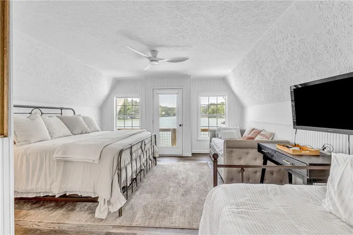 This airy bedroom offers serene waterfront views and comfortable living.