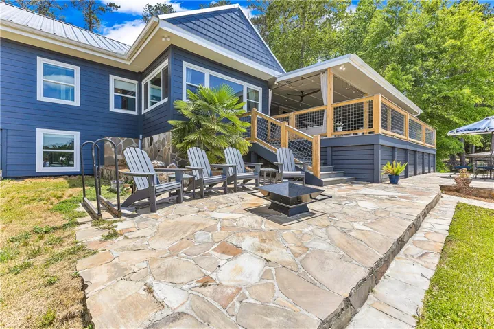 This captivating outdoor area features a spacious patio and an inviting deck.