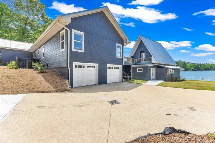 This charming lakeside dwelling offers a private garage and captivating waterfront views.