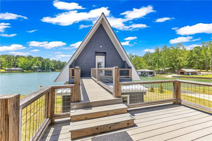 This unique A-frame home offers direct access to the tranquil lake and picturesque natural surroundings.