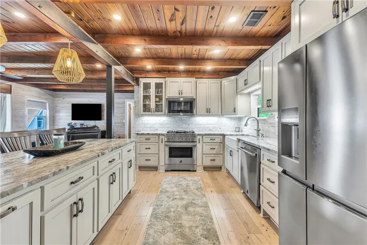 This kitchen features a beautiful ceiling, ample storage, and modern appliances for daily living.
