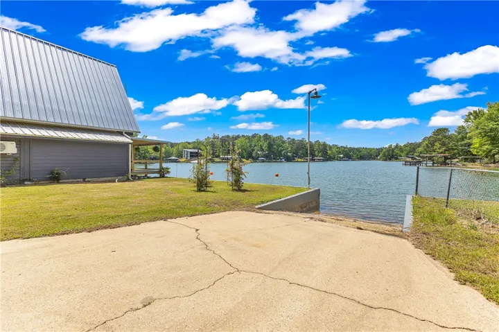 This tranquil waterfront property offers direct lake access and a charming covered patio.
