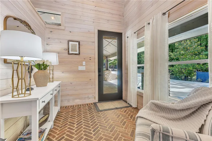 This inviting entry features durable brick flooring and bright windows.