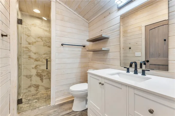 This bathroom features a contemporary vanity with a sleek sink, creating a serene and functional space.
