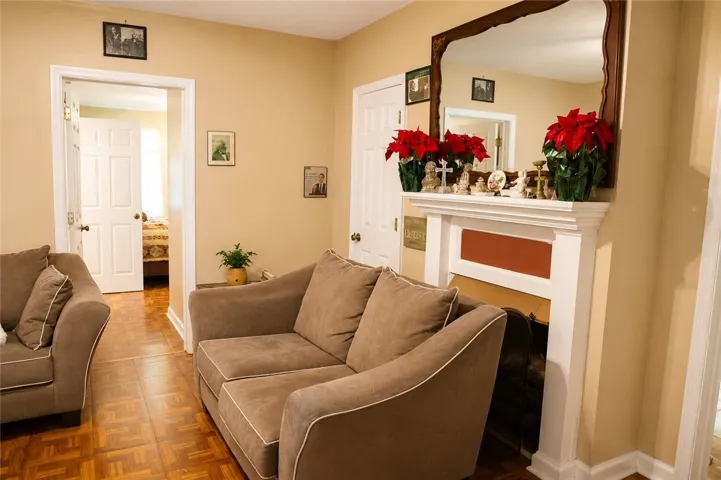 This inviting living space features warm tones and an elegant fireplace, offering a cozy retreat.
