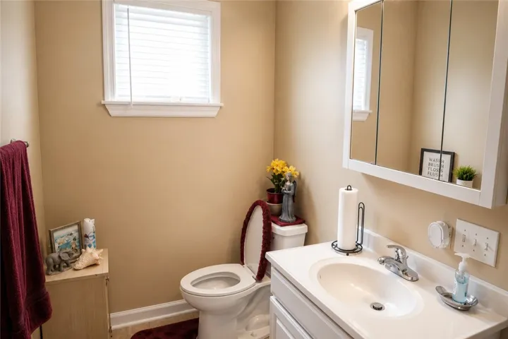 This bright bathroom features a spacious vanity, providing ample room for your daily routine.