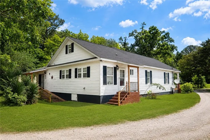 This charming home offers a serene escape, surrounded by lush greenery and expansive outdoor space.