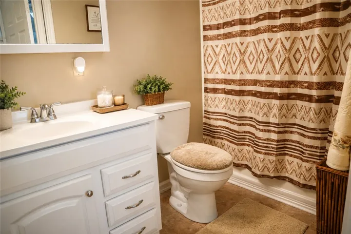 This clean and inviting bathroom features a single vanity, offering both style and everyday functionality.