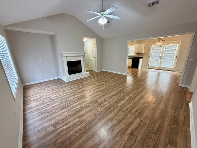 This living area features rich wood flooring, a charming fireplace, and abundant natural light.