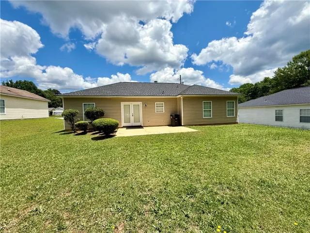 The expansive yard offers ample space for outdoor enjoyment and relaxation.
