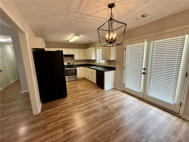 This spacious kitchen offers ample room for culinary endeavors and features convenient outdoor access.