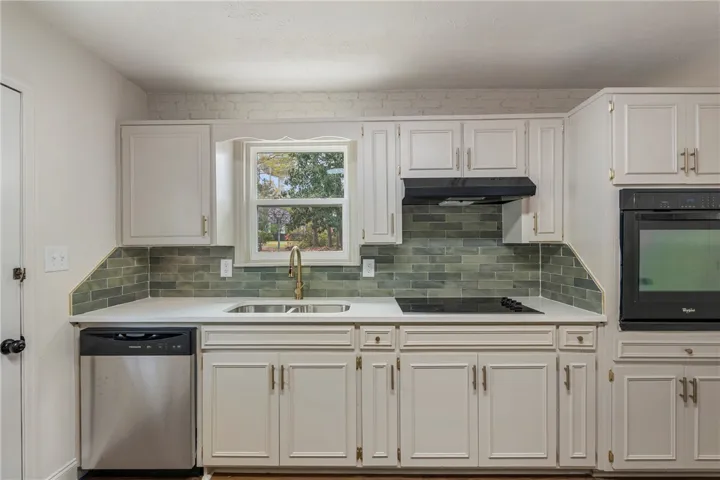 This modern kitchen features sleek appliances and ample counter space, perfect for culinary endeavors.