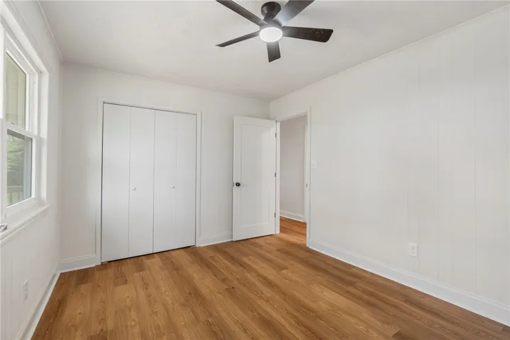 This spacious bedroom offers ample natural light and a practical layout.