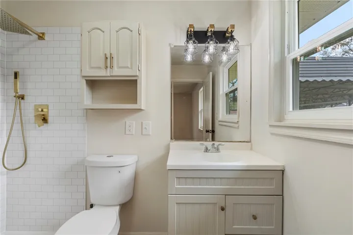 This bathroom features a contemporary vanity and a spacious shower.