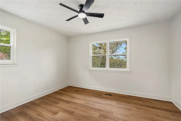 This bright room features durable flooring and ample natural light, perfect for any use.