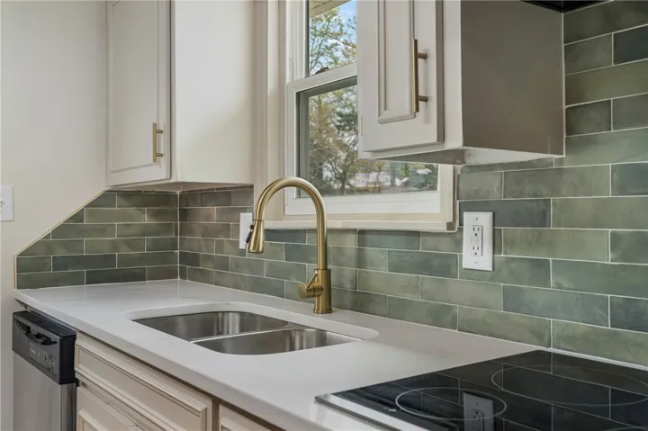 This bright kitchen features sleek appliances and ample counter space.