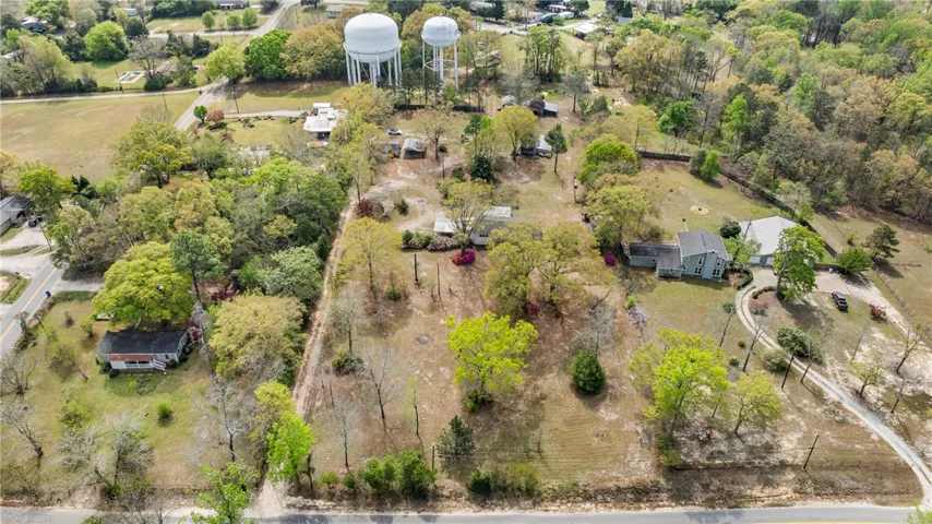 This expansive aerial view showcases a vibrant landscape with homes nestled among lush trees and natural surroundings.