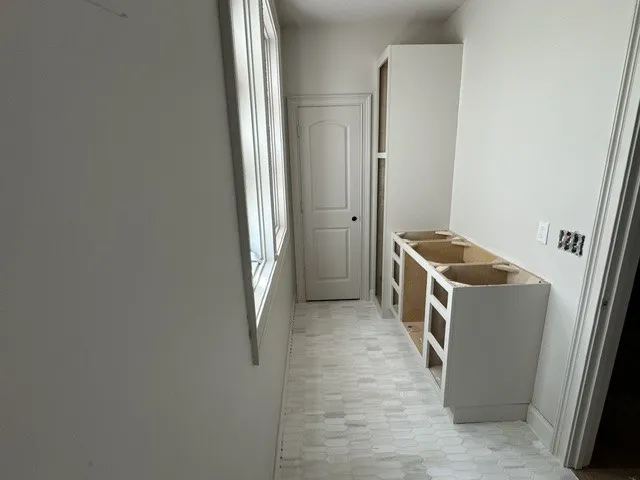 Tiled flooring and tall windows create a bright foundation for this custom storage area.