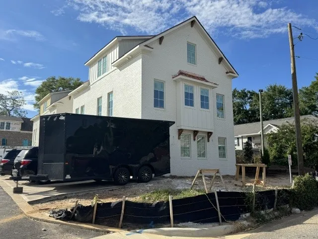 A striking modern multi-level exterior displaying prominent gables and classic architectural corbels.