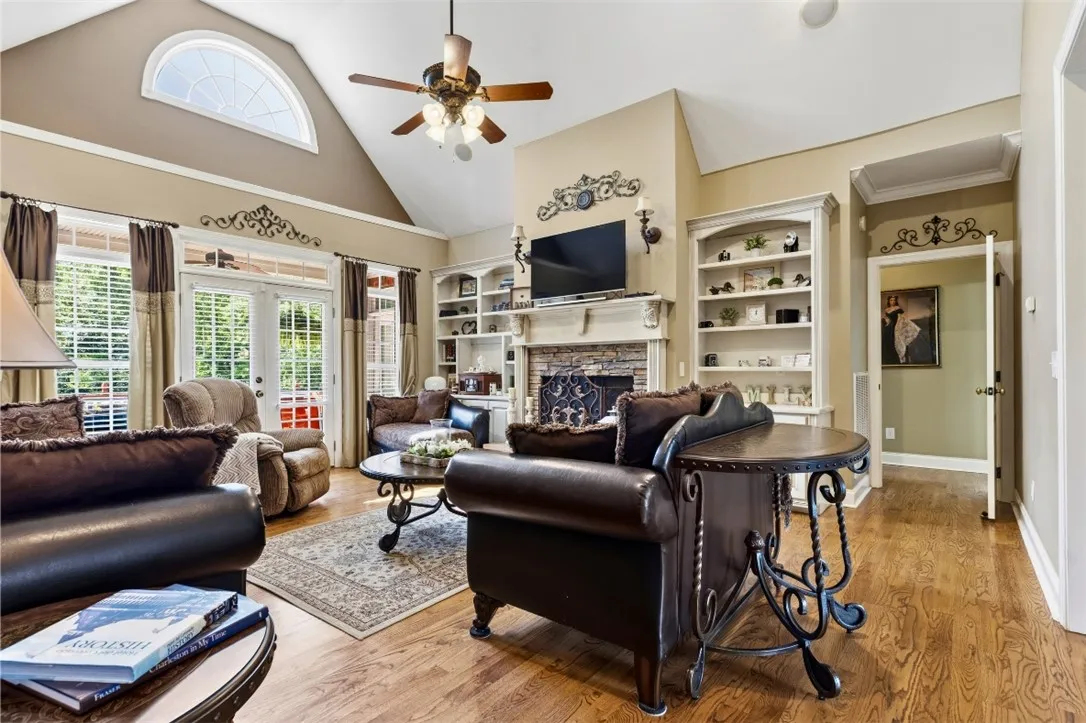 The great room has vaulted ceilings, built-in shelving, and a cozy gas log fireplace, perfect for gatherings.