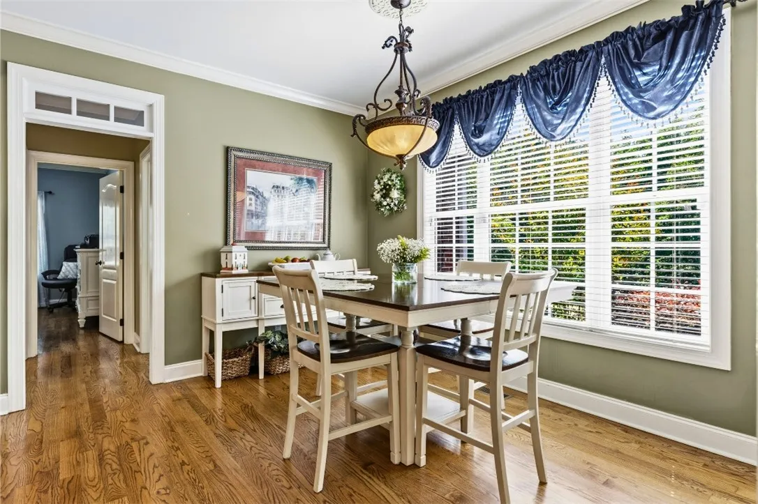 The breakfast room has warm hardwood flooring and ample natural light - a perfect place to start your day or for family meals.
