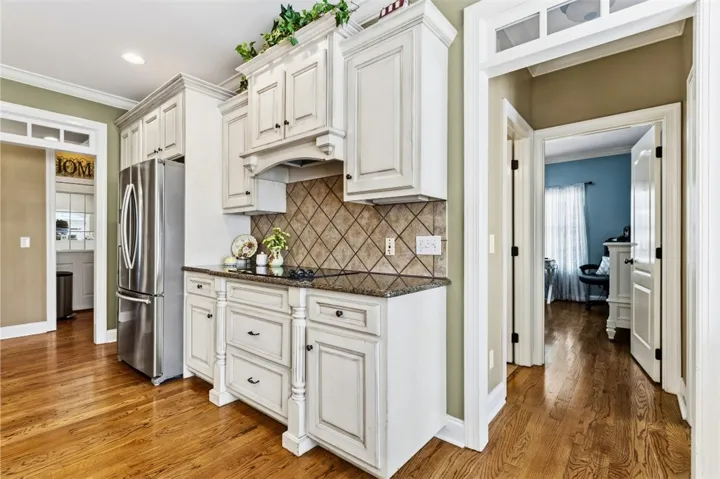 The kitchen is bright with warm wood floors and is ready for culinary creativity.