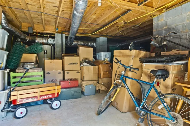 The crawl space has a floored area perfect for storing lawn equipment out of the elements.