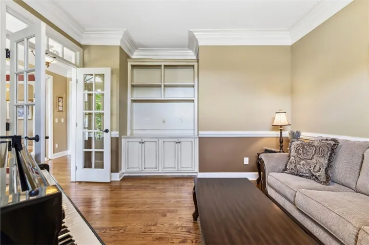 The flex room features French doors and built-in shelving.