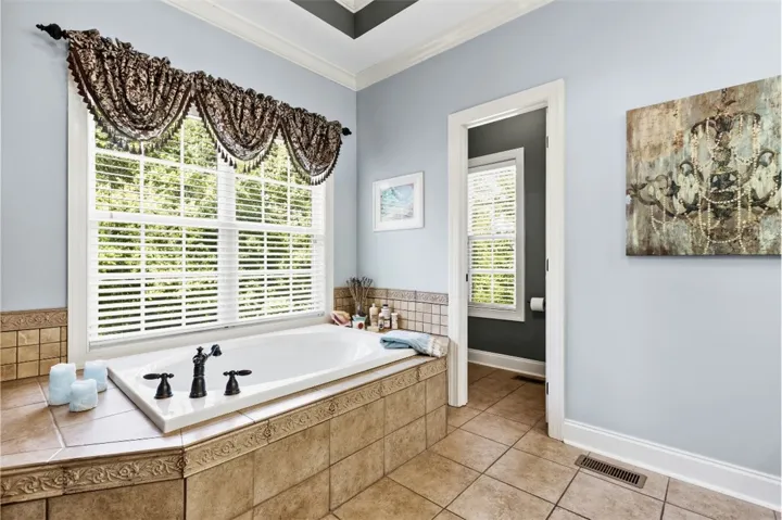 Relax in this inviting bathroom featuring a bubble tub (not jetted) and ample natural light.