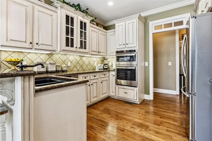 The kitchen has ample cabinetry and integrated appliances for modern living.