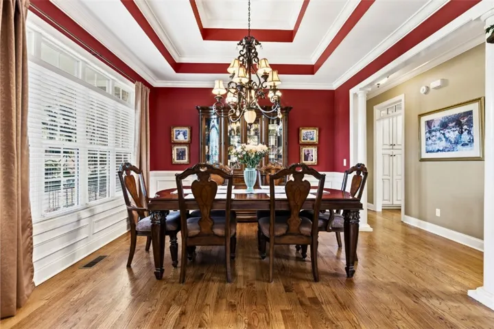 The dining room is full of natural light and has a striking tray ceiling.
