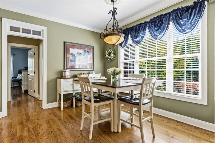 The breakfast room has warm hardwood flooring and ample natural light - a perfect place to start your day or for family meals.