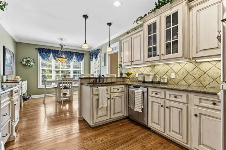 The spacious kitchen offers ample cabinet space and flows seamlessly into a bright breakfast room.